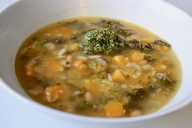 This Orzo and Pumpkin Soup is topped with a nutty pesto.