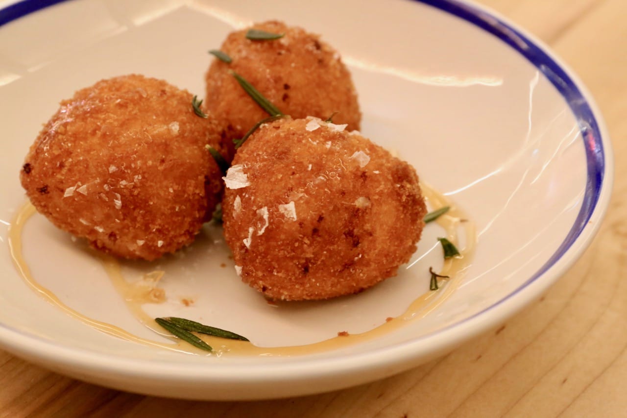 Arancini with smoked cheese, pear, pancetta, rosemary and burnt honey
