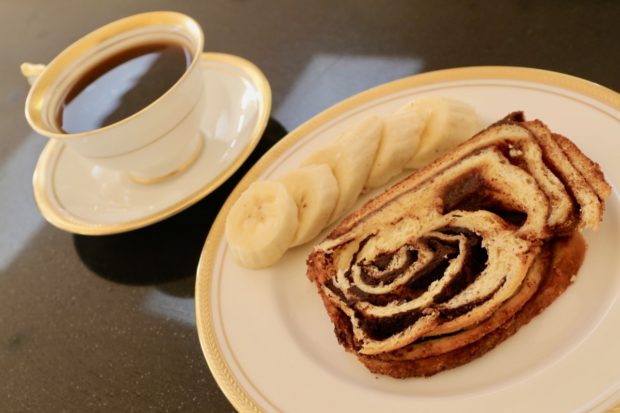 Cinnamon Babka enjoyed at breakfast with a cup of coffee and sliced banana. 