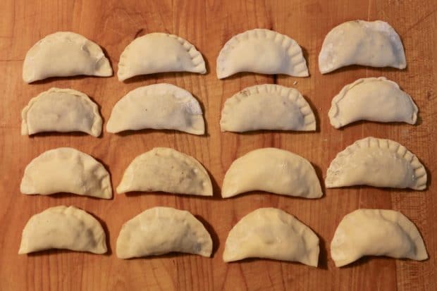 Onced filled, homemade pierogies are closed by pinching with your fingers or tines of a fork. 