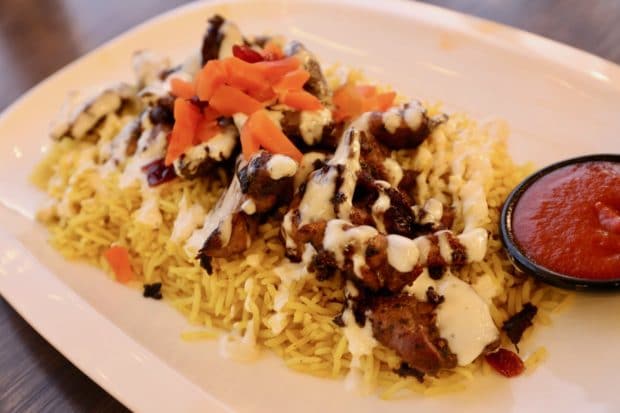 Chicken and beef shawarma are served at Masrawy Kitchen with seasoned rice, garlic sauce and hot sauce.