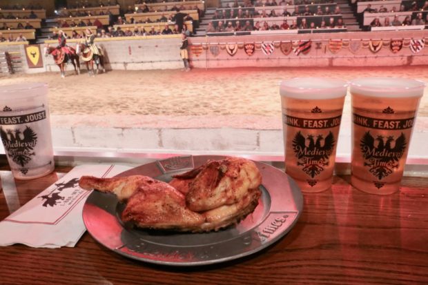 Eating a half roasted chicken with your hands slurping beer at Medieval Times Toronto.