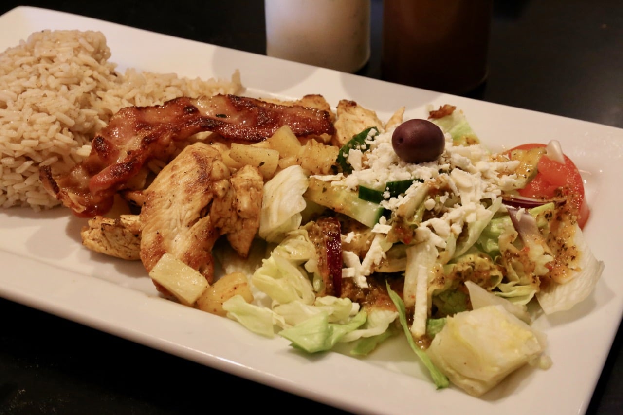 Chicken Pineapple is served with crispy bacon and a Greek salad.