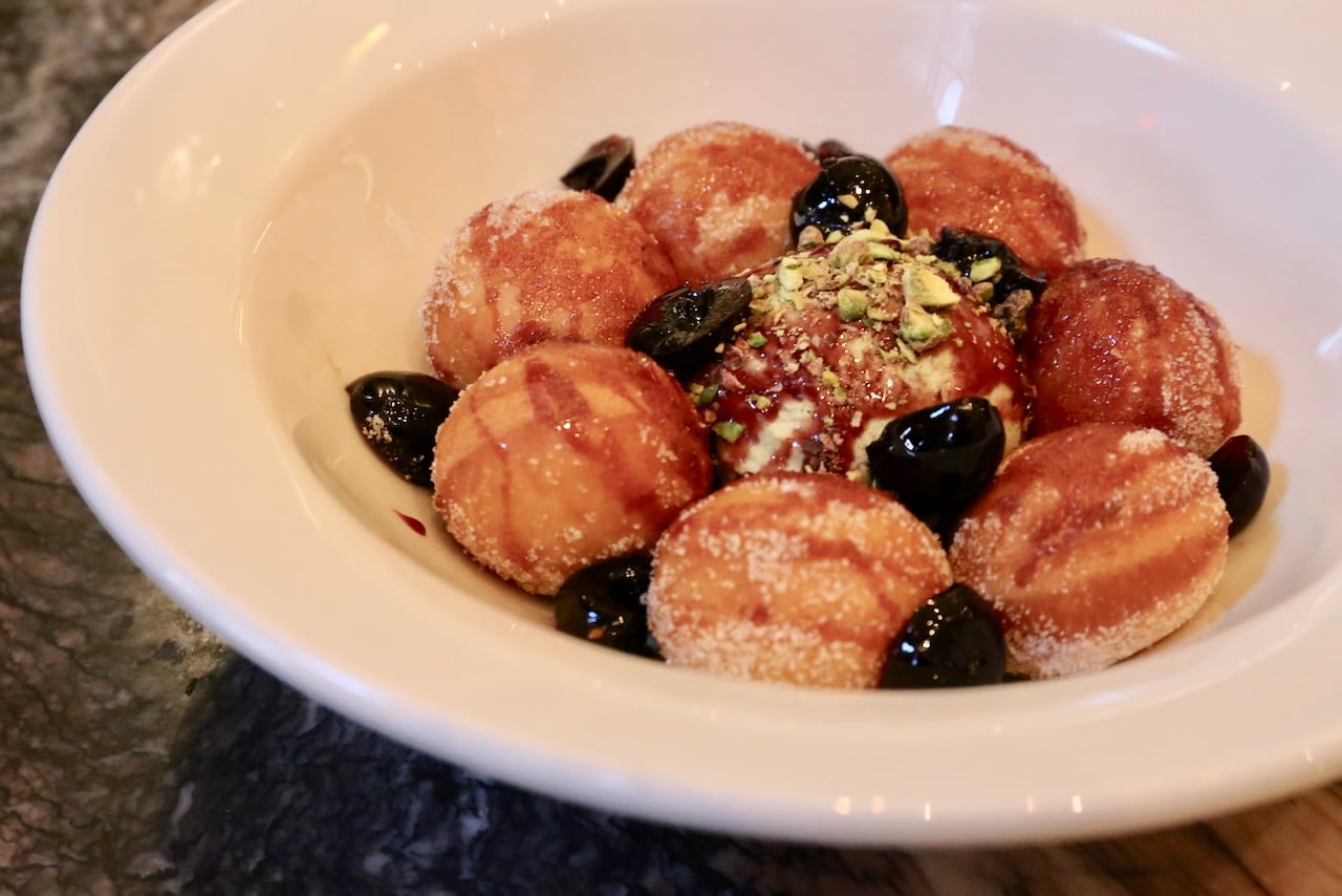 Loukoumades are soft donuts served with pistachio ice cream and amarena cherries.