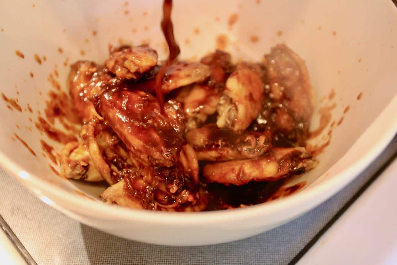 After the first bake, toss half-cooked wings in Ssamjang chicken sauce.