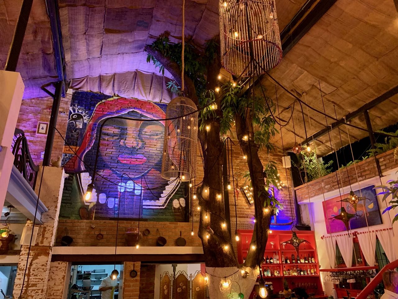 Merida Grill's dining room features bird cages and magical Mayan mural.