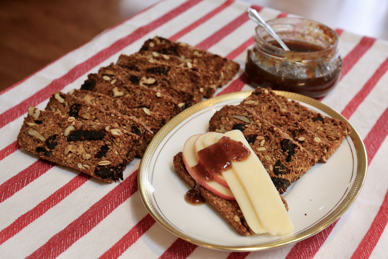 Raincoast Crisps gourmet crackers served with sliced apples, cheddar and fig jam.