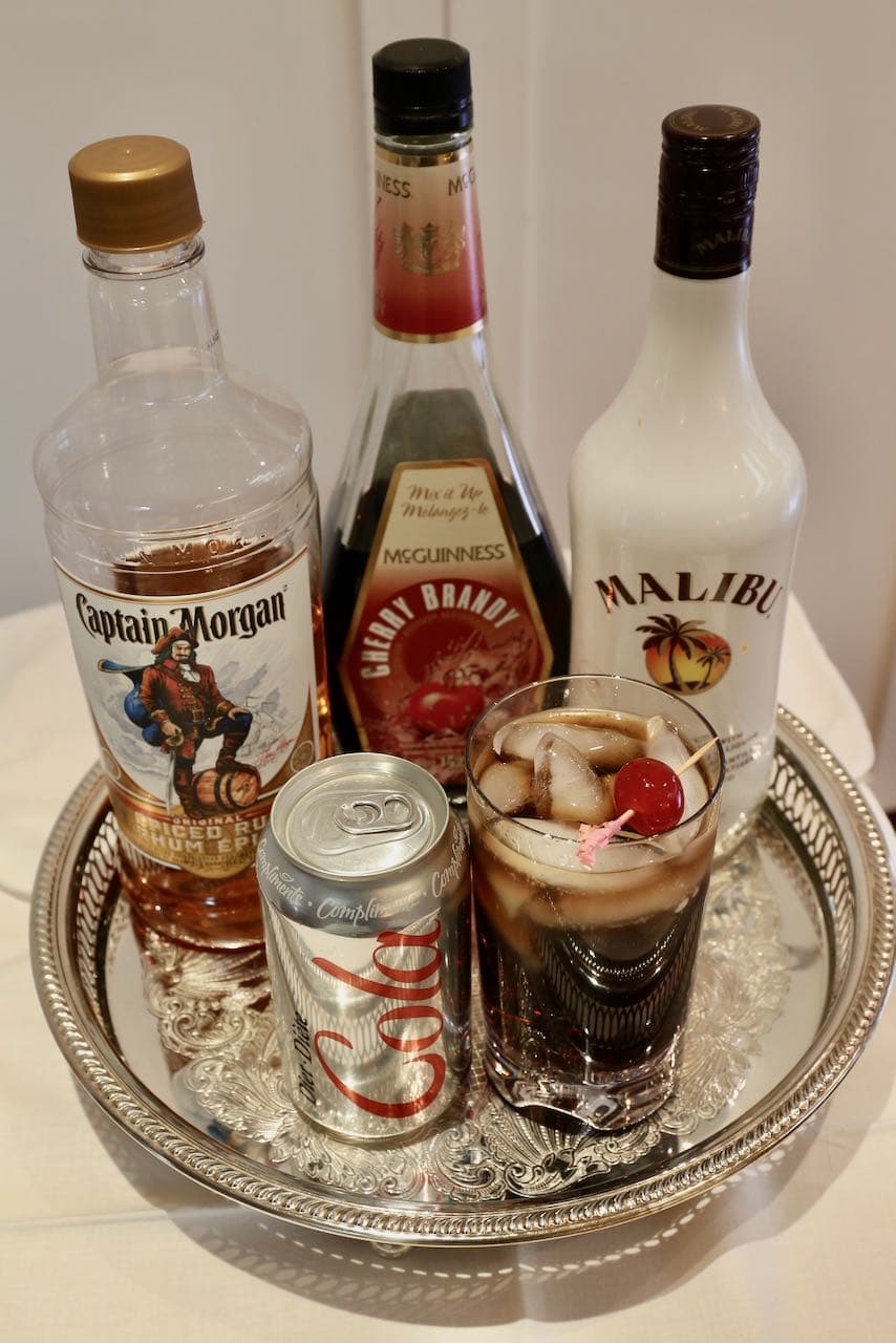 Enjoy a gay Pride cocktail on the beach with rum, cola and cherry brandy.