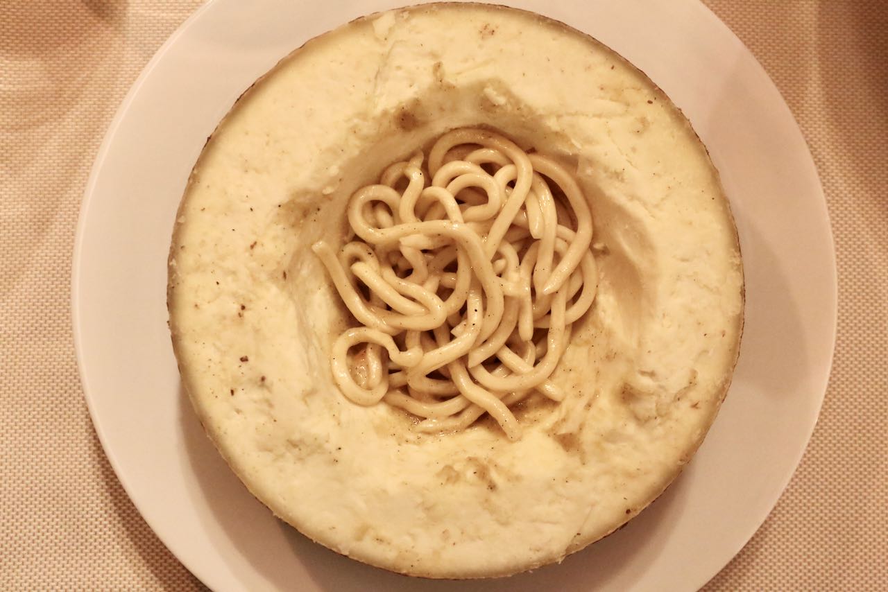 Pici Cacio e Pepe is often tossed in pecorino cheese at restaurant tables in Tuscany. 