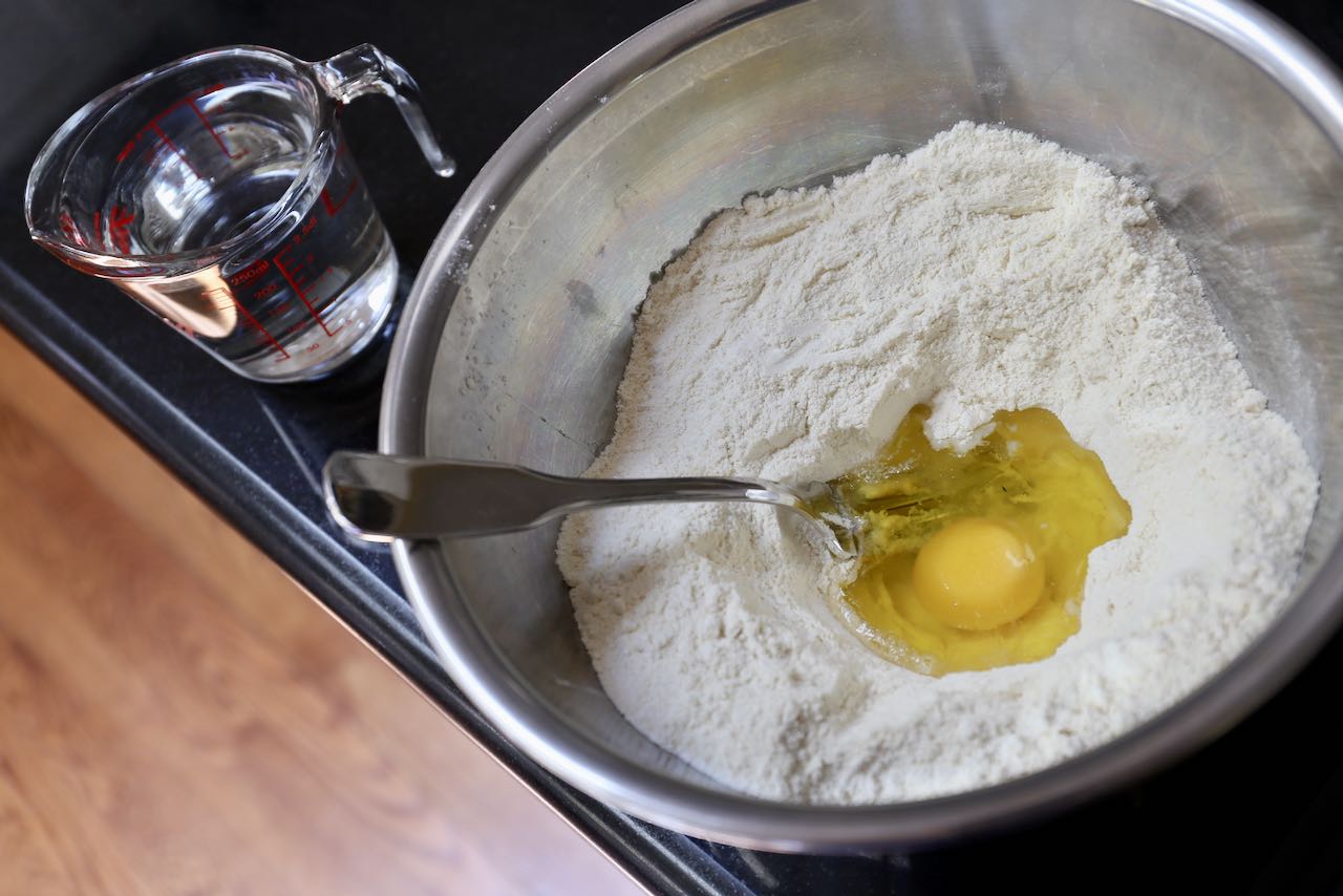 Prepare pici pasta dough with flour, egg, olive oil and water.