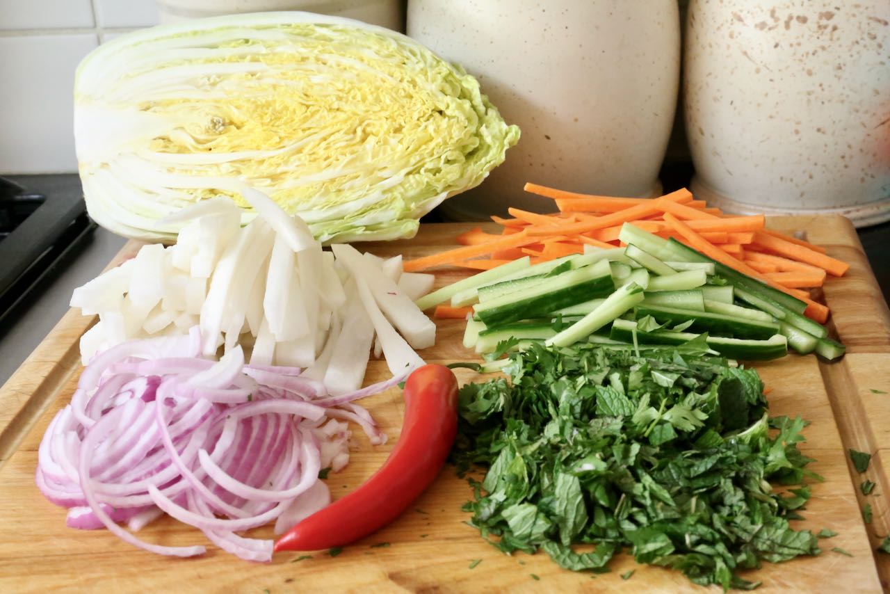 Start your Goi Ga Vietnamese chicken salad by chopping and slicing the vegetables and herbs.
