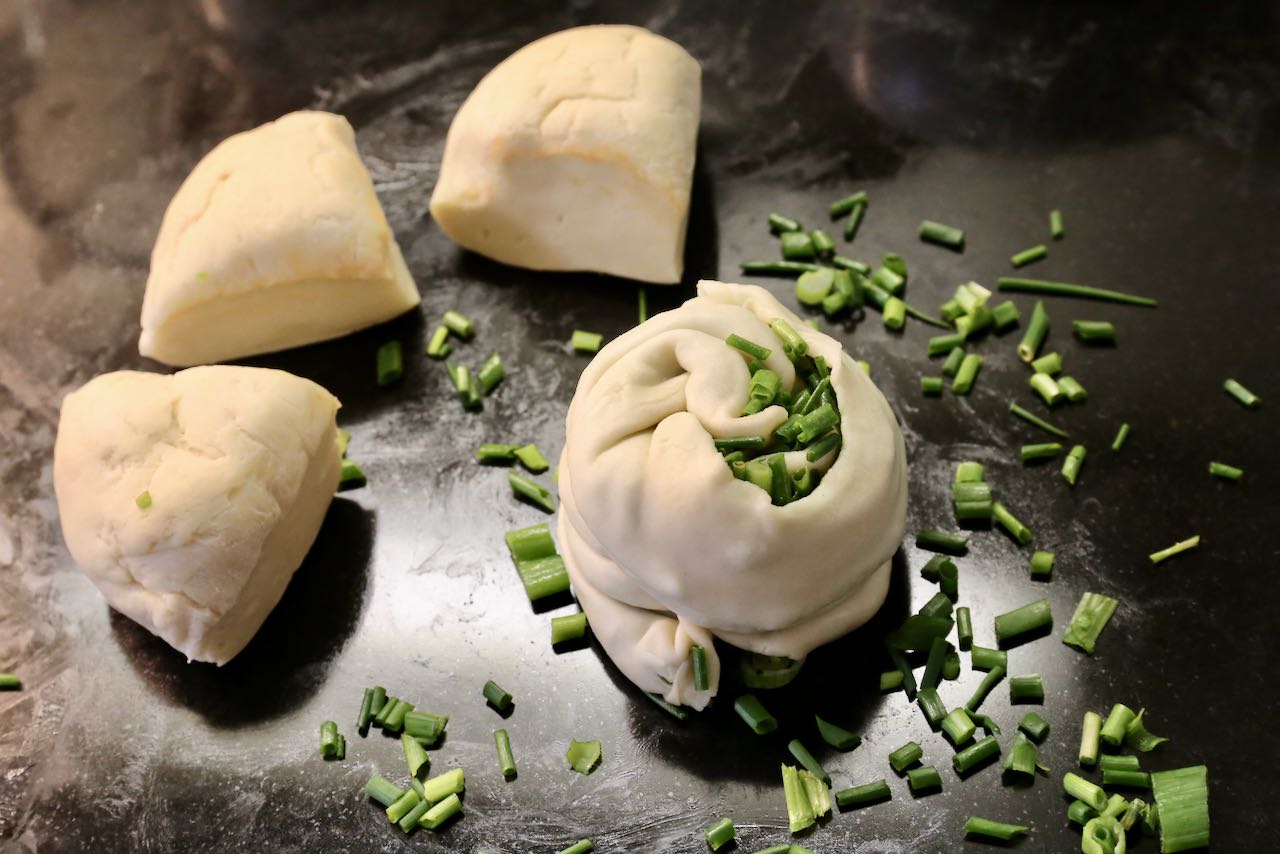 Fold the dough onto itself like an accordion to make cute Green Onion Cake parcels.