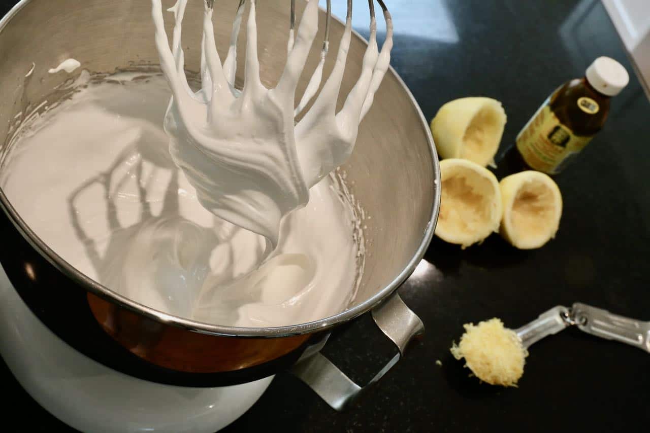 Start making Lemon Angel Pie by whipping meringue to stiff peaks.