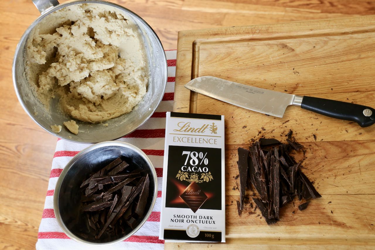 Chop Lindt dark chocolate bars and add them to the cookie dough.
