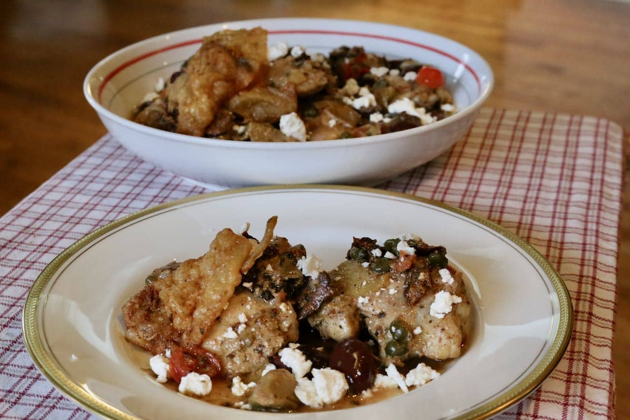Serve Mediterranean Chicken Thighs family-style from a large serving bowl.