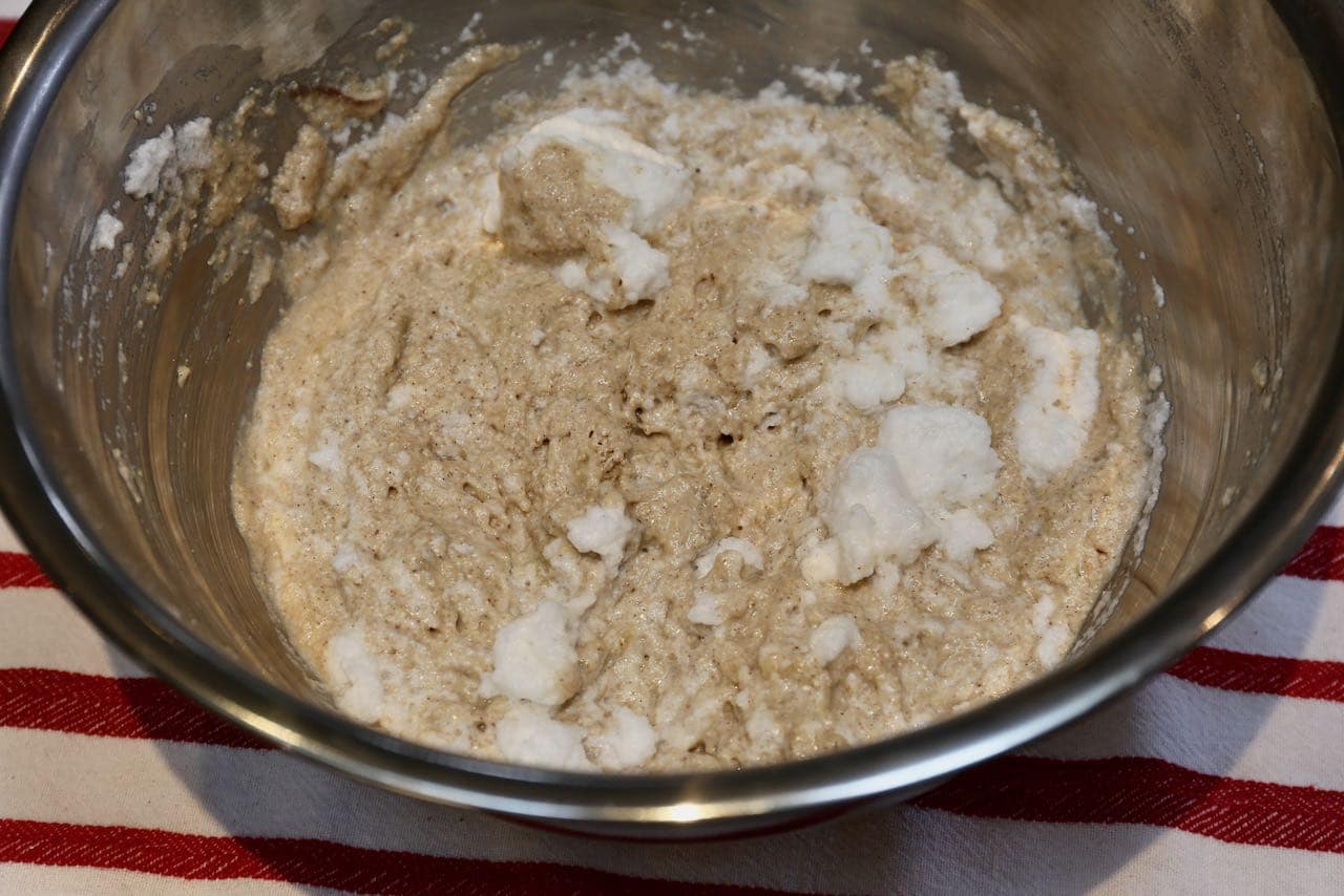 Slowly fold whipped egg whites into oat flour pancakes batter.