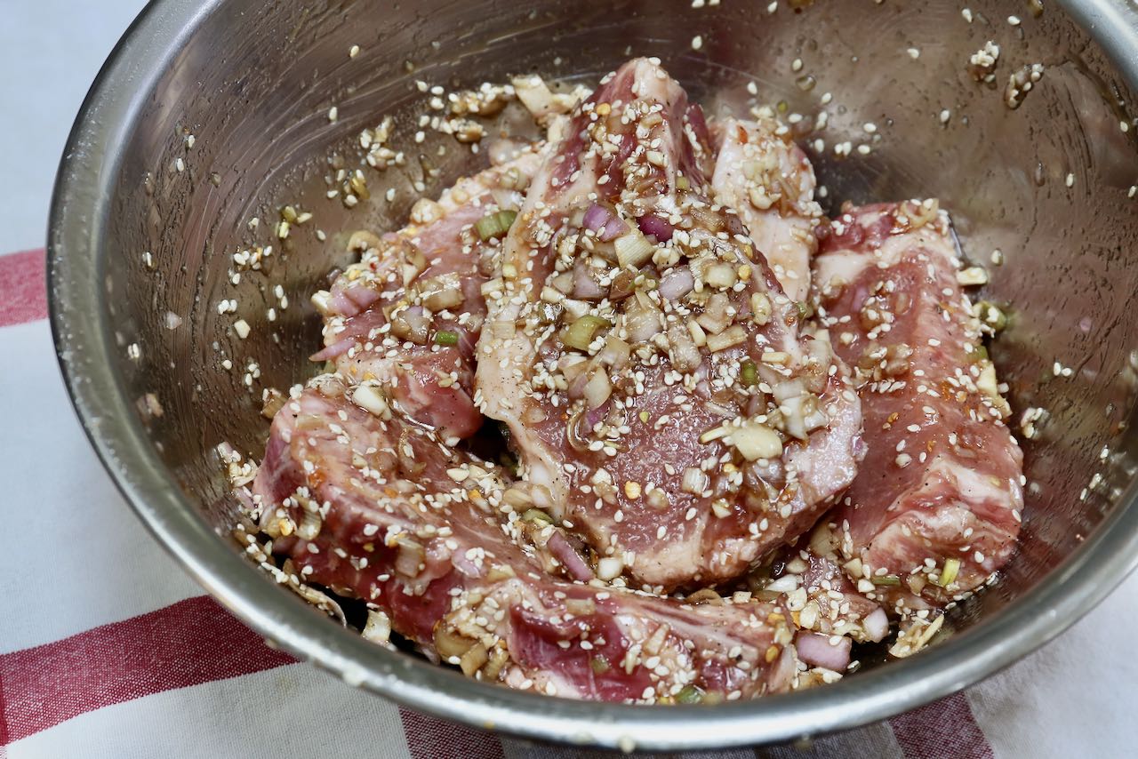 Use your hands to toss and fully coat pork with marinade. 