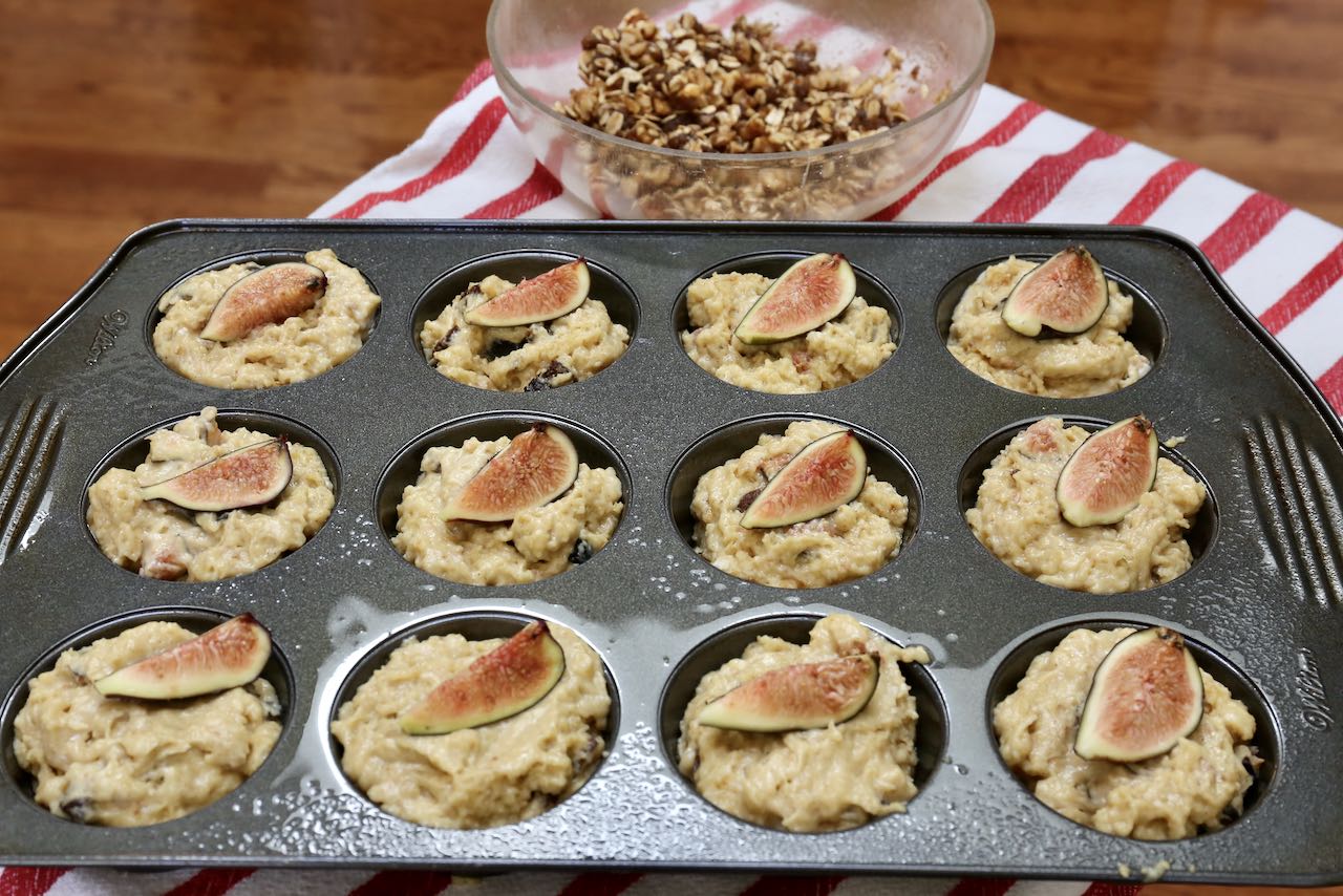 Fill Fresh Fig Muffin batter into a greased tin and top with fresh fig slice.