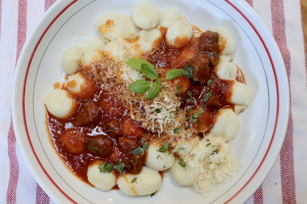 Serve Instant Pot Short Rib Ragu over gnocchi topped with parmesan cheese.
