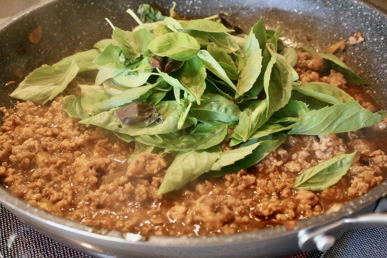 Once the minced pork is cooked with the with sauce add Thai basil leaves.