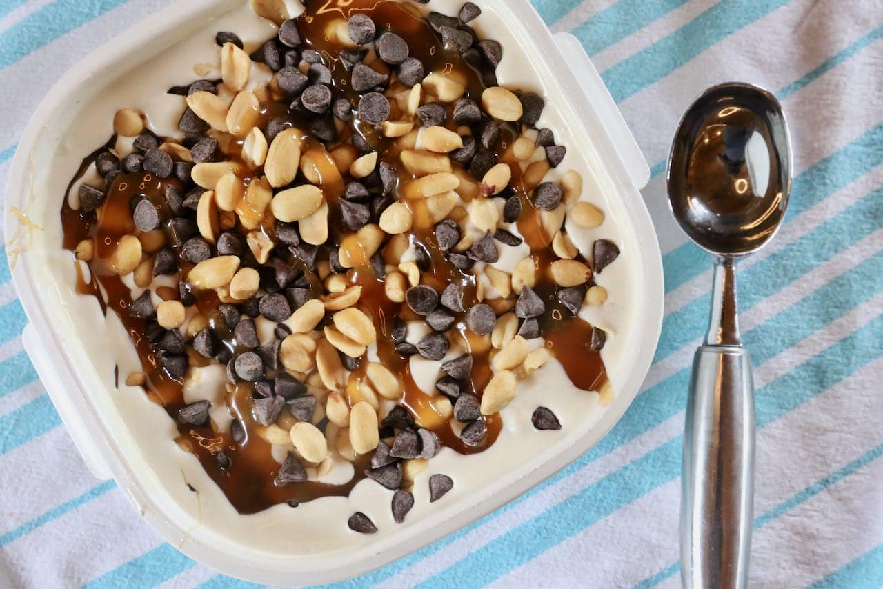 Top Banana Nut Ice Cream with roasted peanuts, chocolate chips and caramel drizzle.