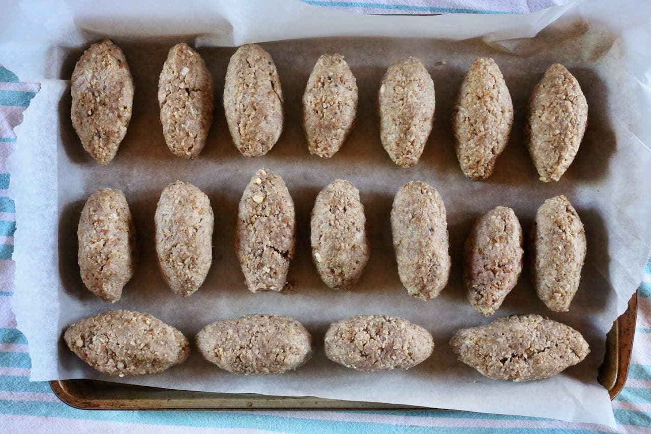 Store Lebanese Kibbeh coquettes on a baking sheet in the fridge until ready to deep fry.