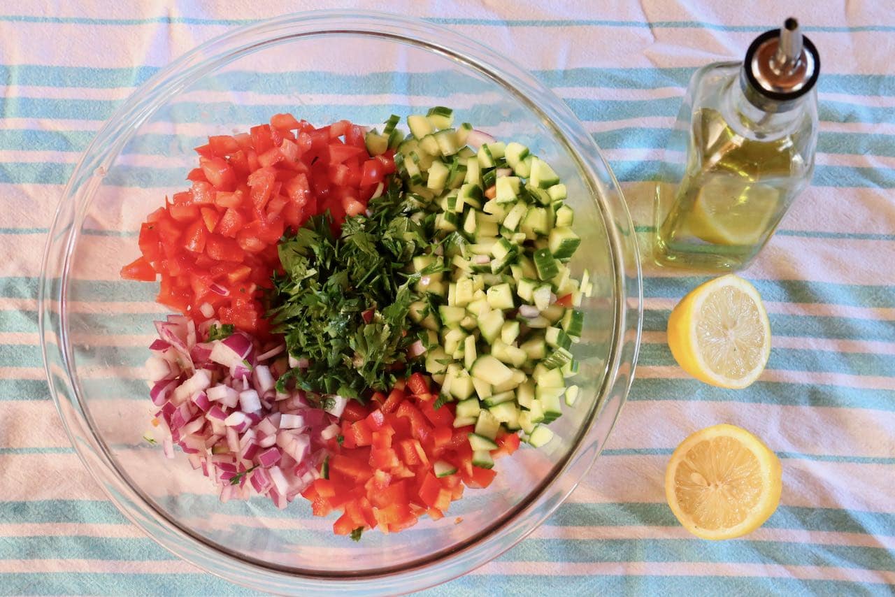 Toss Egyptian Salad ingredients with olive oil and lemon juice.