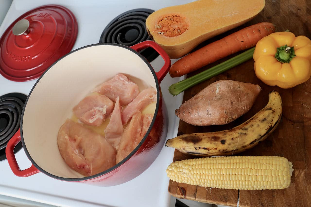 Start cooking Ajiaco Cubano by sauteing chicken breasts in a large pot. 