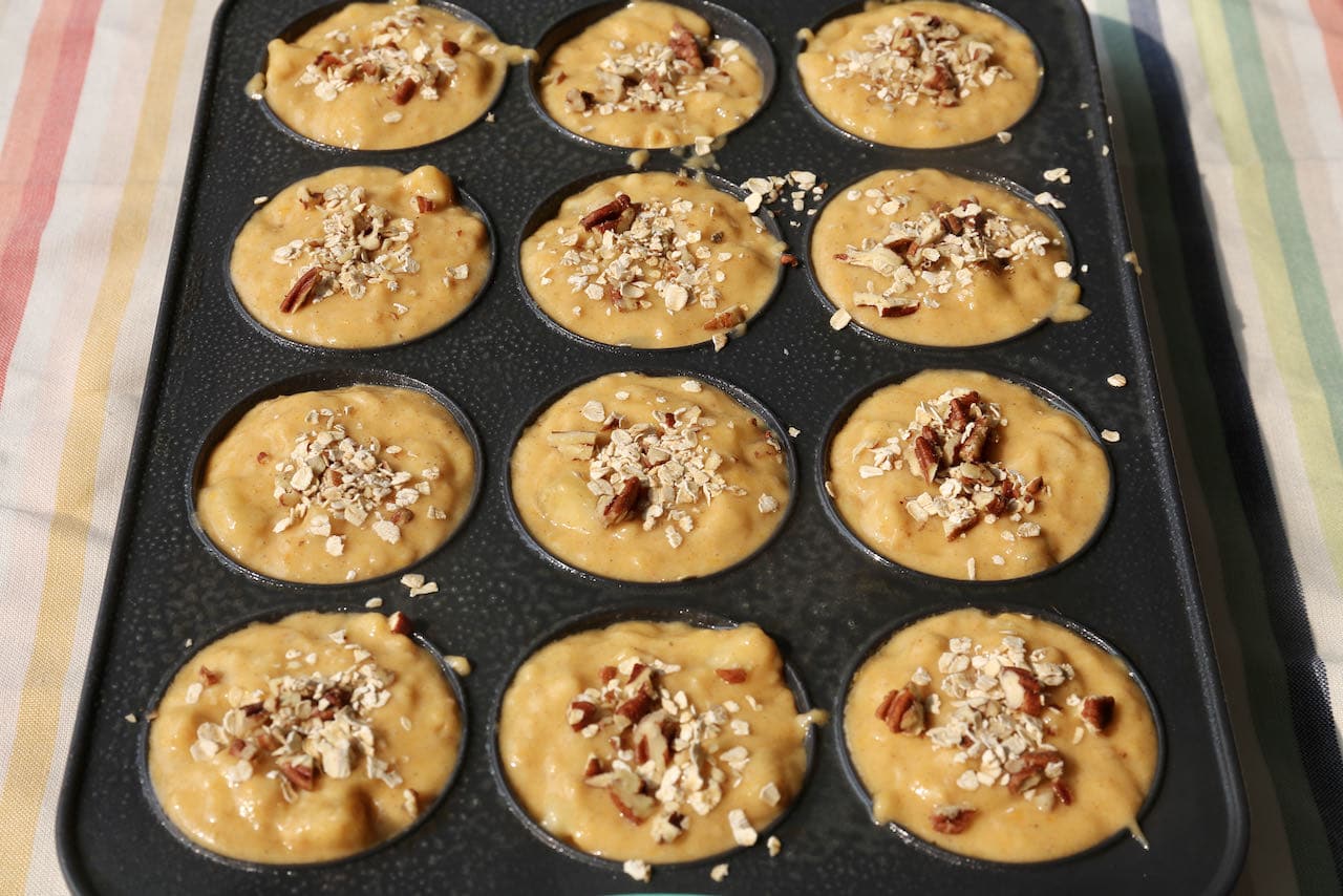 Top Banana Pumpkin Muffins with oats and chopped pecans.