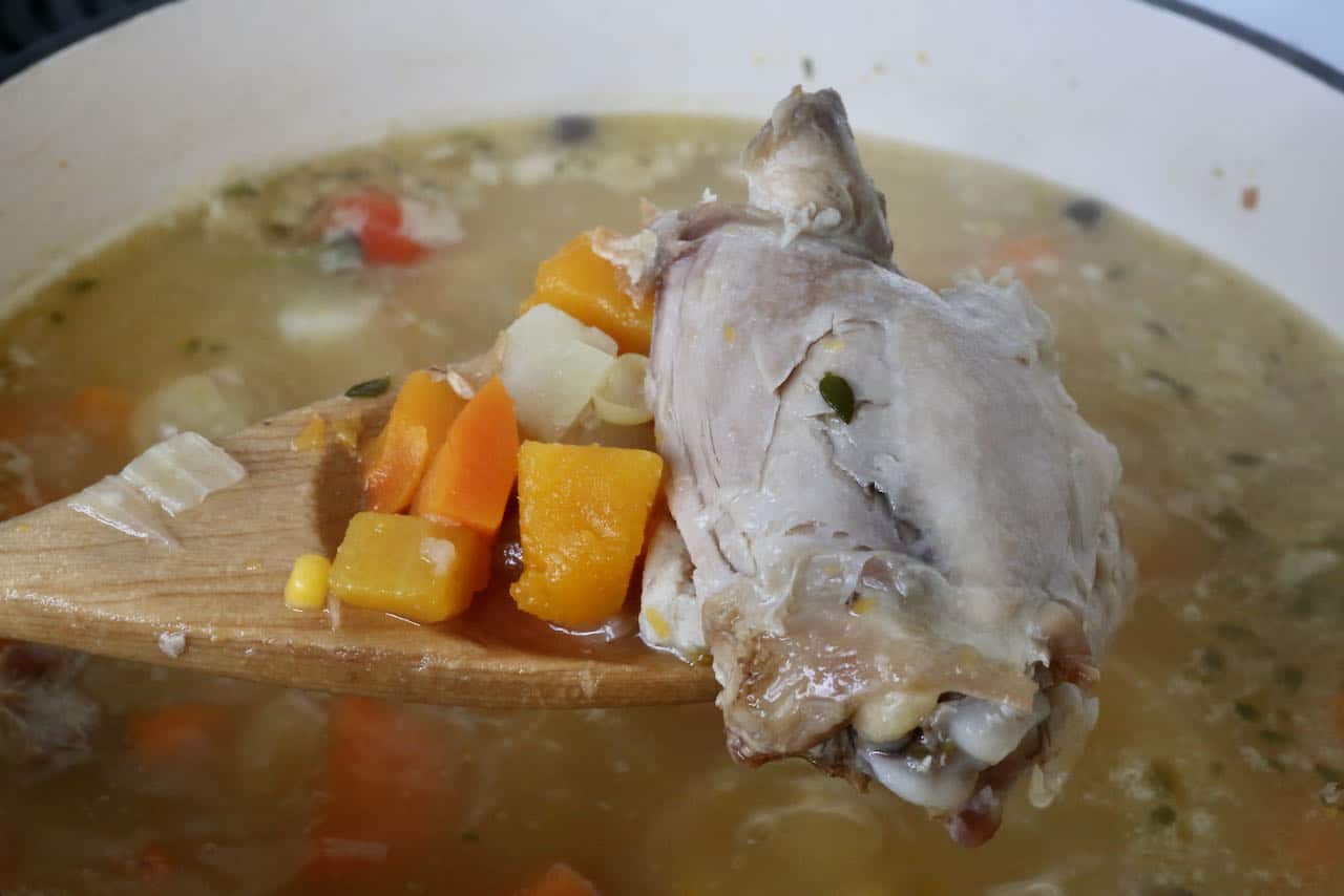Jamaican chicken soup is finished cooking once thigh meat falls off the bone.