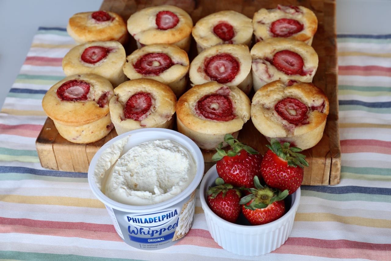 Serve Strawberry Cheesecake Muffins with fresh strawberries and Philadelphia cream cheese.