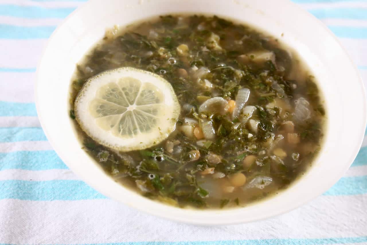 Serve homemade Lebanese Lentil Soup with a slice of lemon.