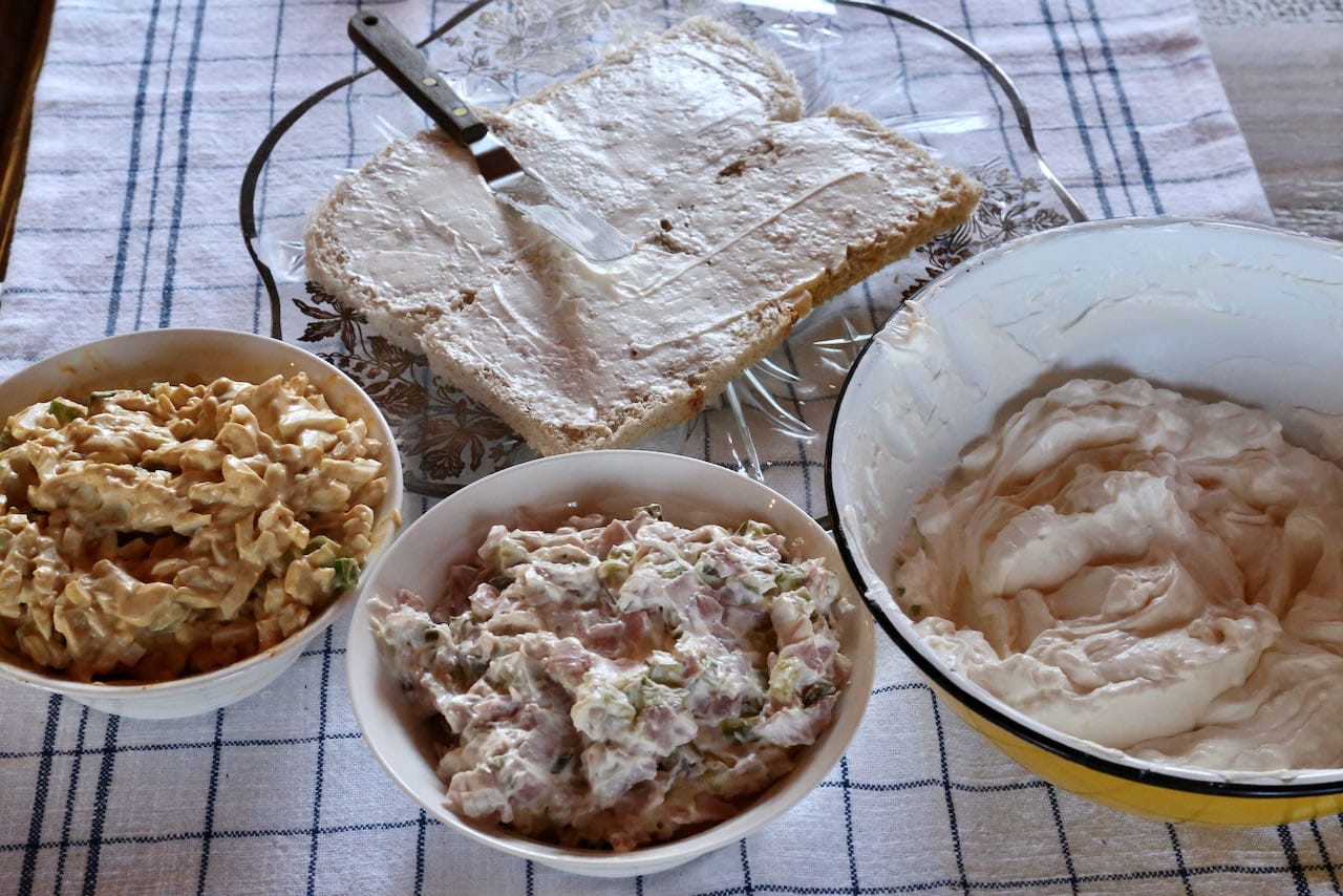 Start building your Smörgåstårta by slathering 4 bread slices with "savoury icing."