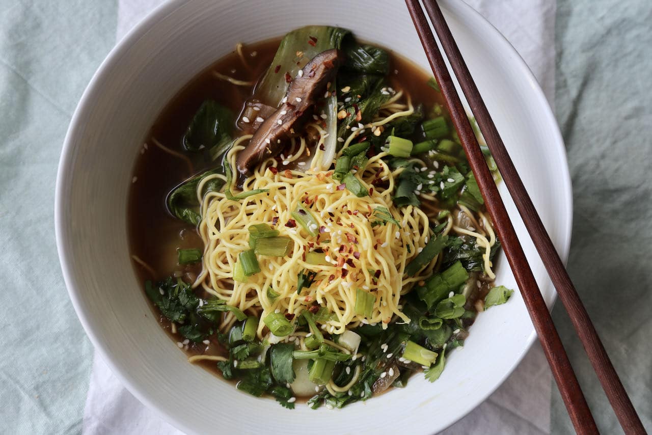 Serve Ginger Garlic Soup with chopsticks and spoon in a large pho-sized bowl.