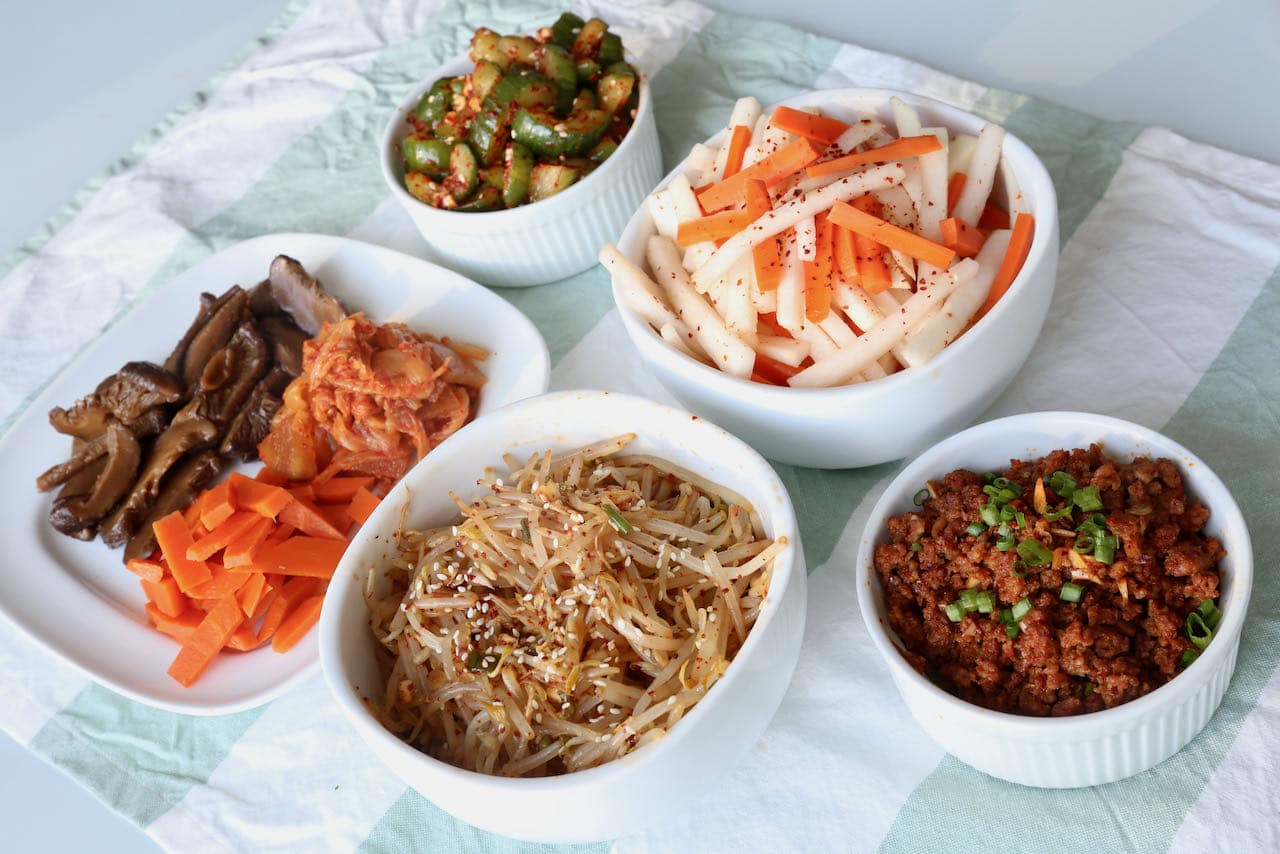 Spicy Pork Bibimbap is topped with a selection of healthy Korean banchan.  