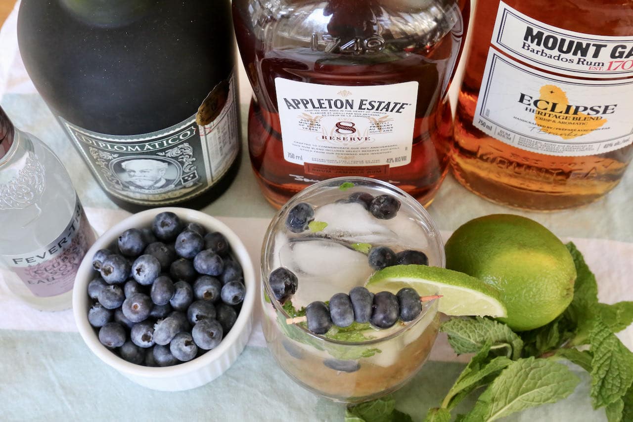 Our easy Blue Mojito recipe is garnished with lime wedge and fresh blueberries.