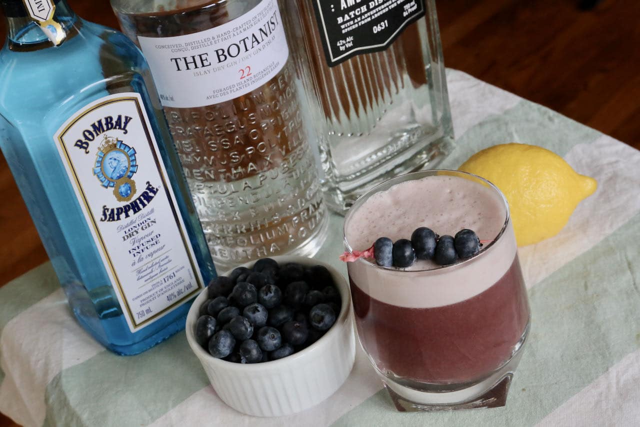 Blueberry Gin Cocktail ingredients include gin, blueberry juice, lemon juice, egg white, lemon bitters and fresh blueberries.