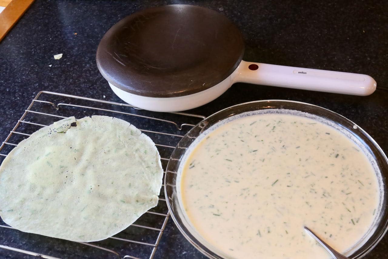Use an electric crepe maker or crepe pan to cook homemade Flädle German pancakes. 