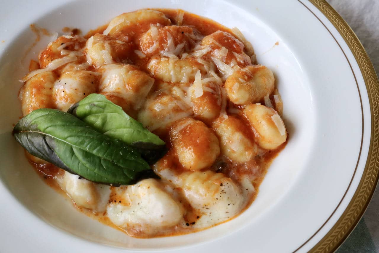 Serve our easy Gnocchi Caprese in pasta bowls topped with grated parmesan and basil.