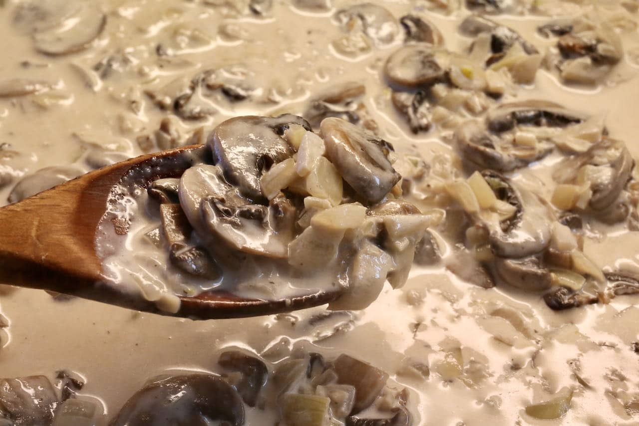 Kartoffelknödel are covered in a creamy mushroom sauce.