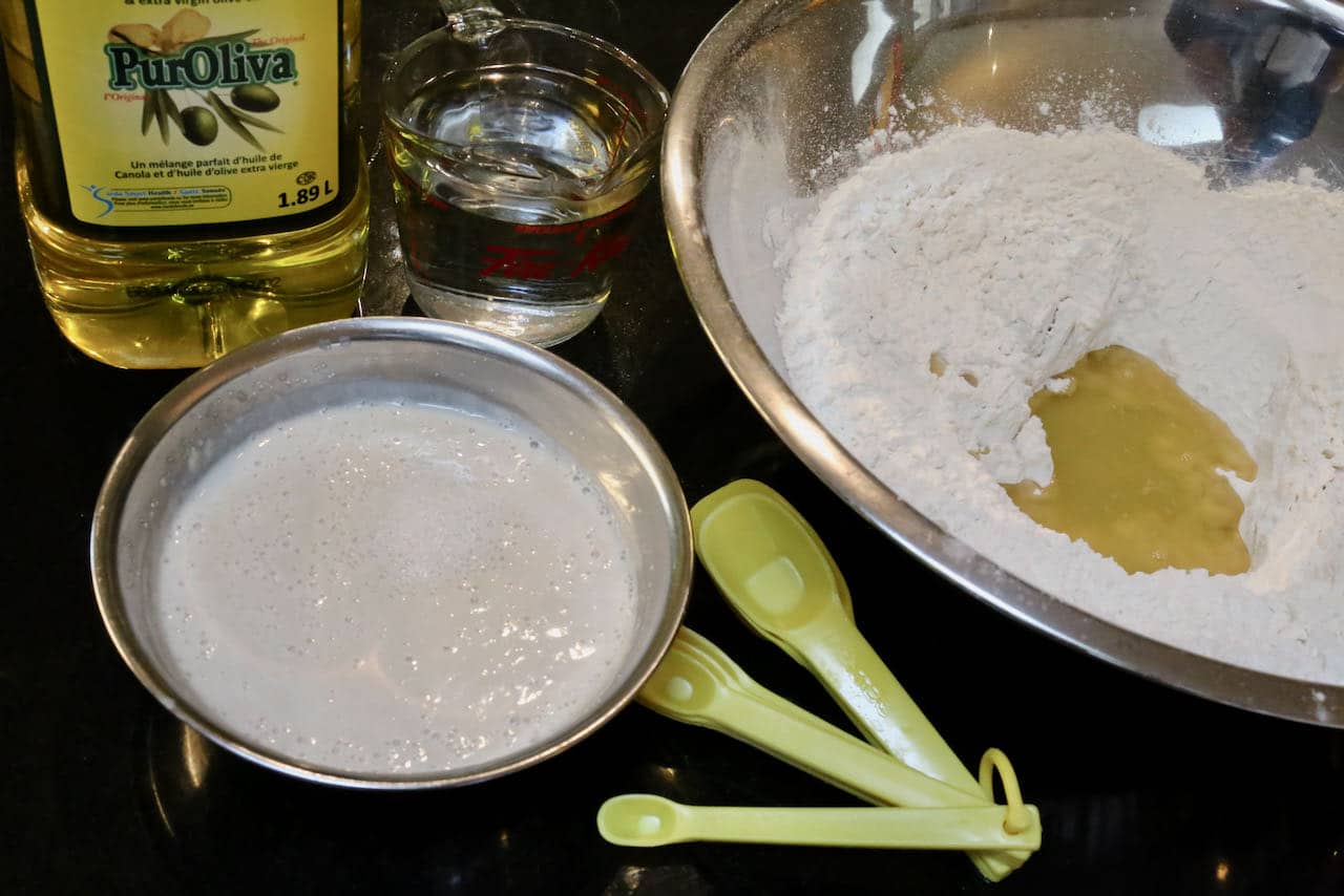 Prepare Peynirli Pide dough by combining flour, yeast, olive oil and warm water.