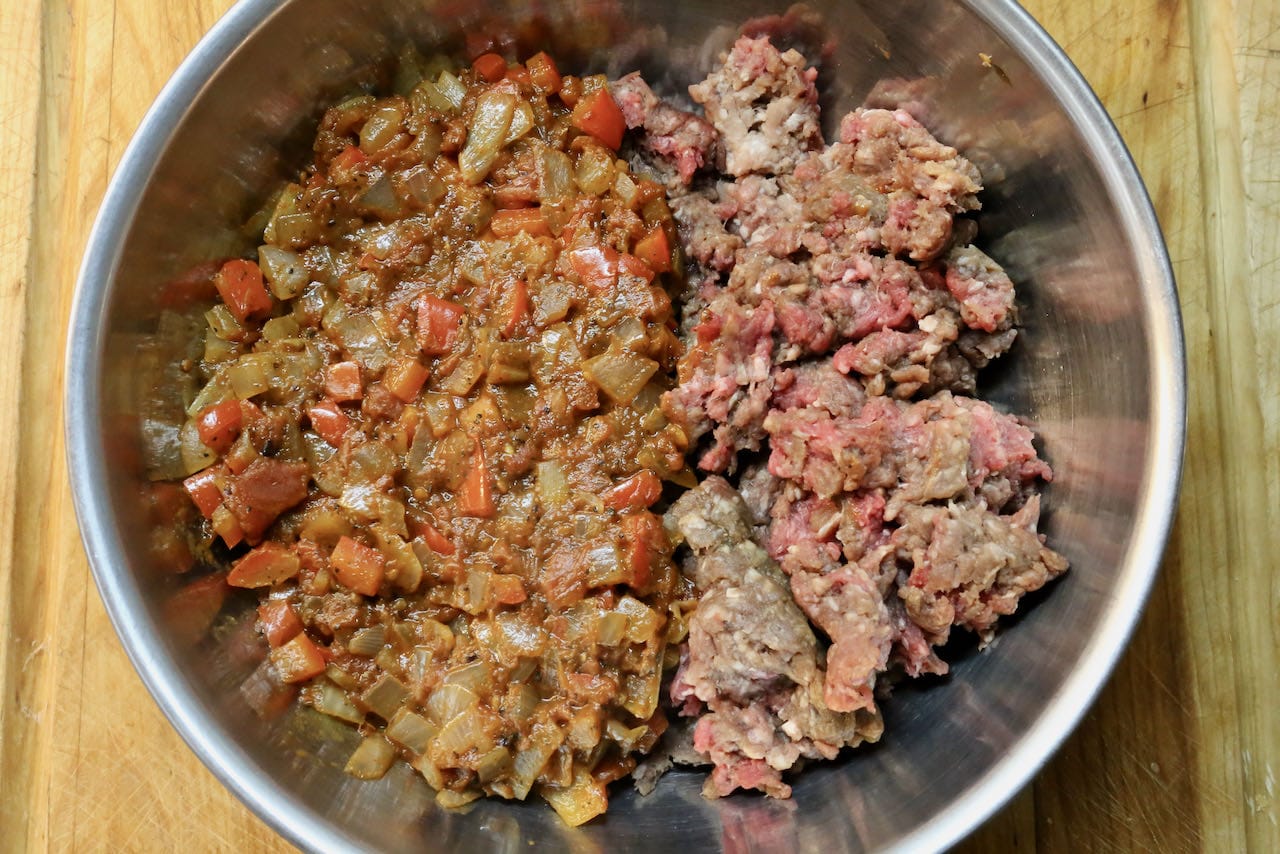 In a mixing bowl combine minced beef and sauteed vegetables with your hands. 