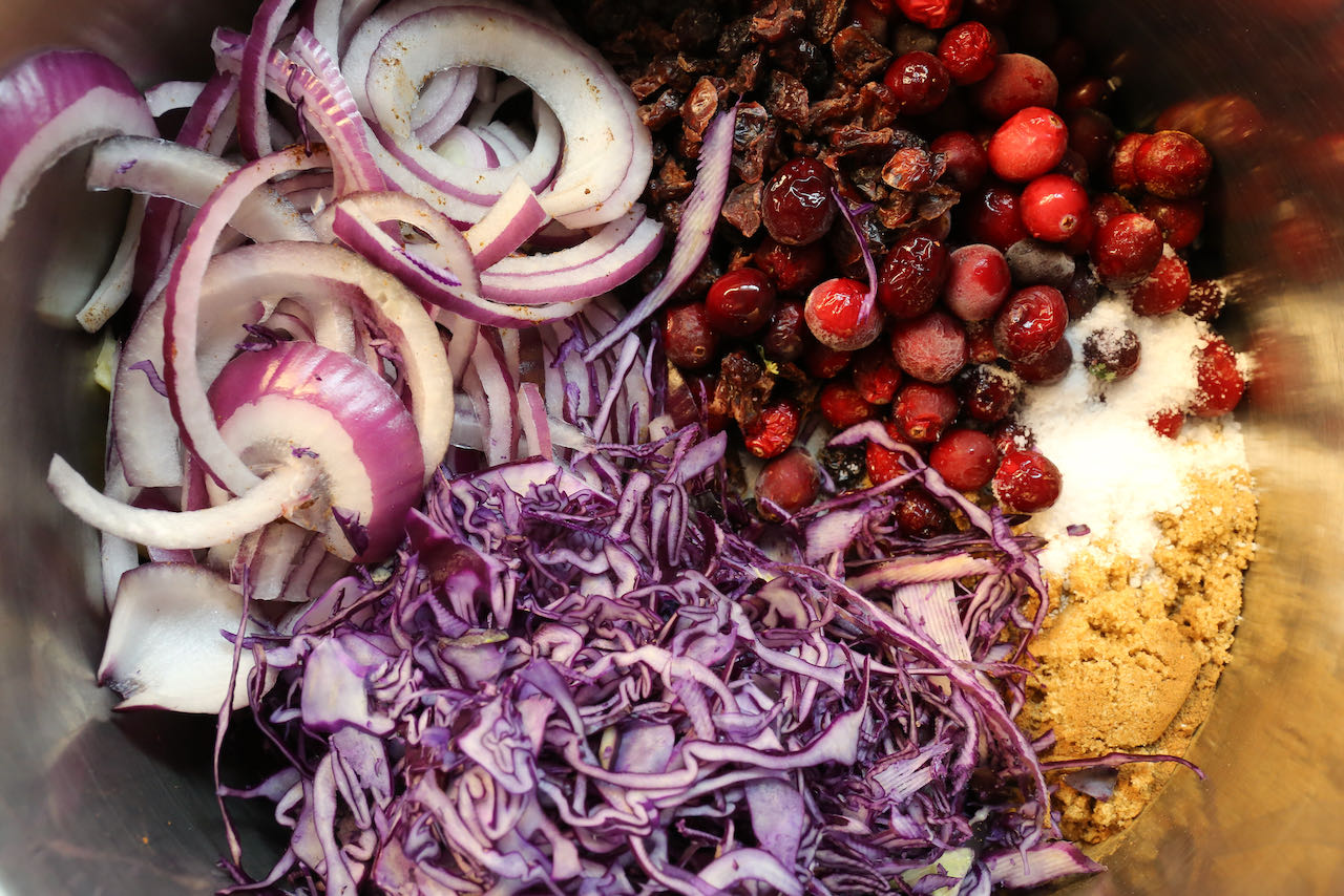 Add red cabbage, onions, apple, cranberries, sugar and salt to a large pot.