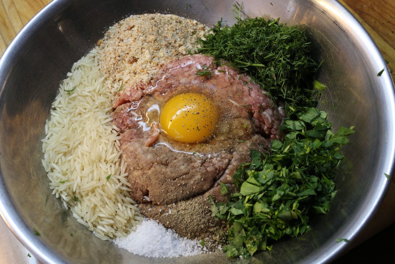 Prepare Ciorba de Perisoare meatballs with rice, fresh herbs, minced meat and egg.