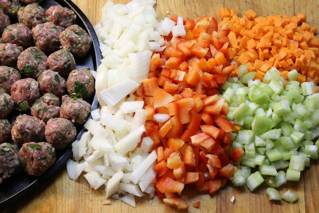 Tradițional Ciorba de Perisoare ingredients include chopped onions, peppers, celery and carrots.