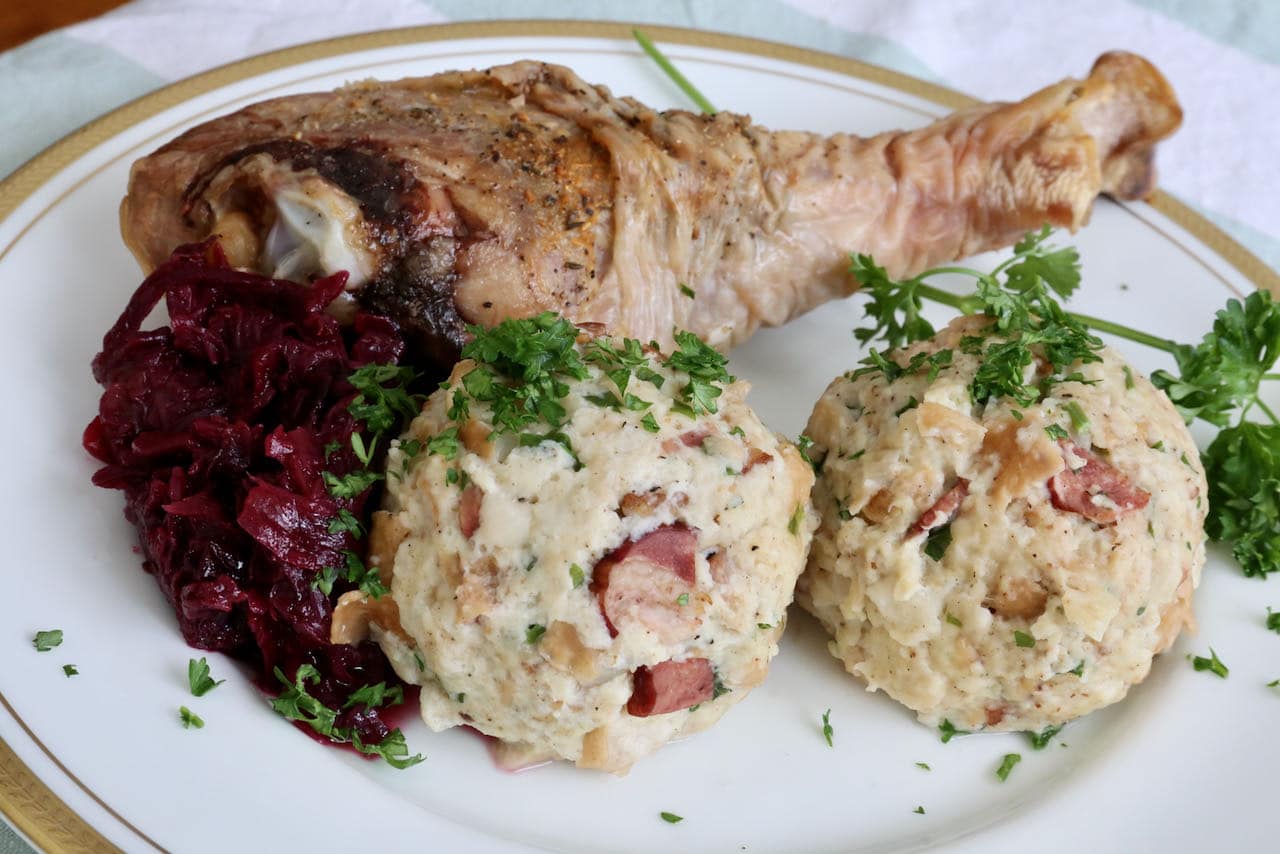 Speckknödel is a popular German side dish served with braised cabbage and roast meat like turkey leg.