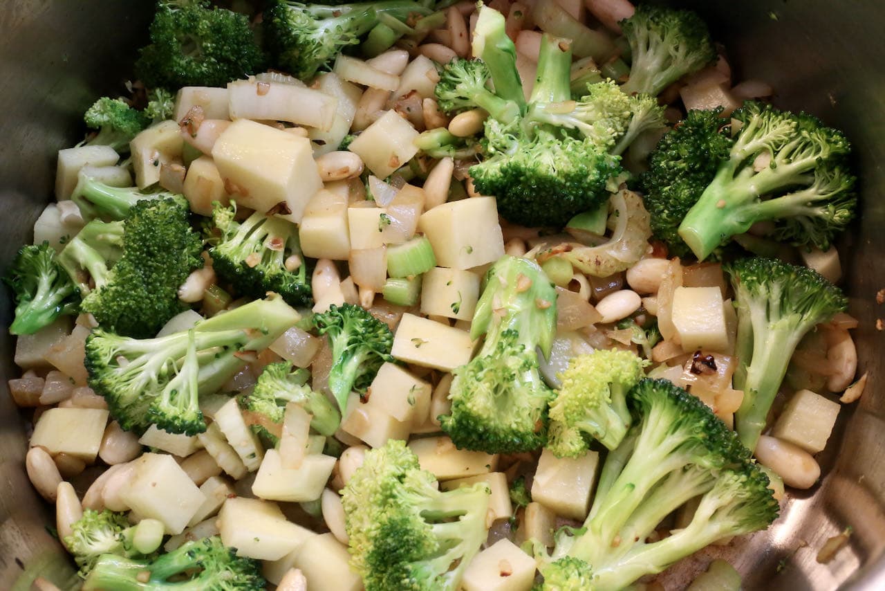 In a large pot saute broccoli, blanched almonds, potato, celery and onion until tender.