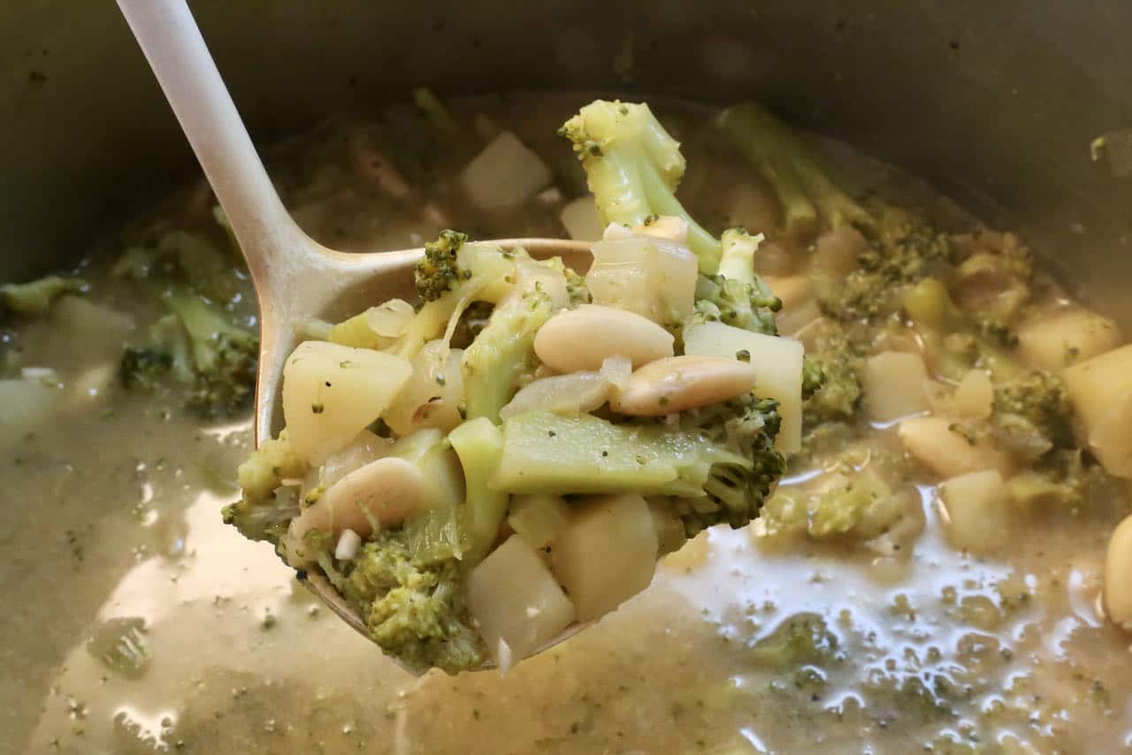 Once the vegetables are cooked, transfer the Broccoli Almond Soup with a ladle to a blender.