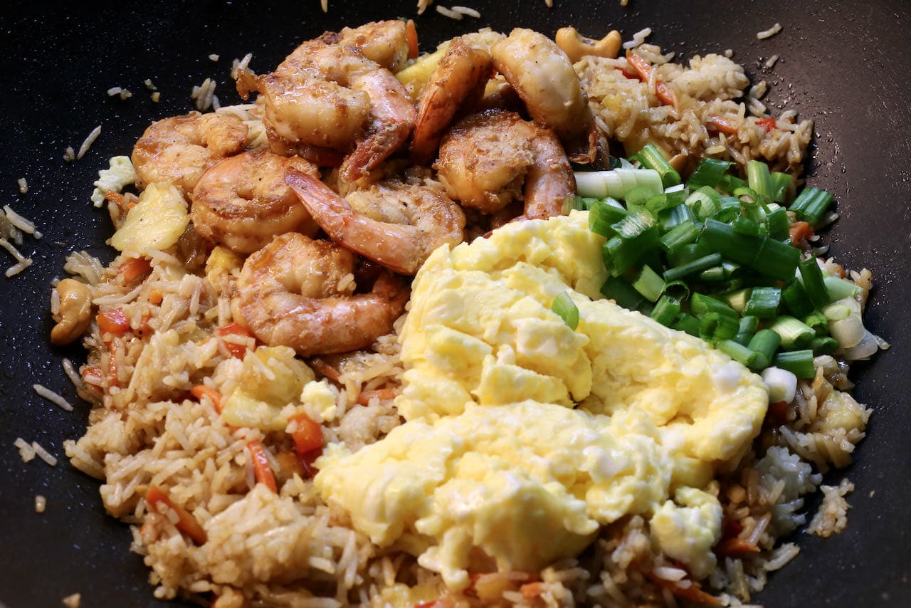 In a large wok combine marinated shrimp, scrambled eggs and scallions.