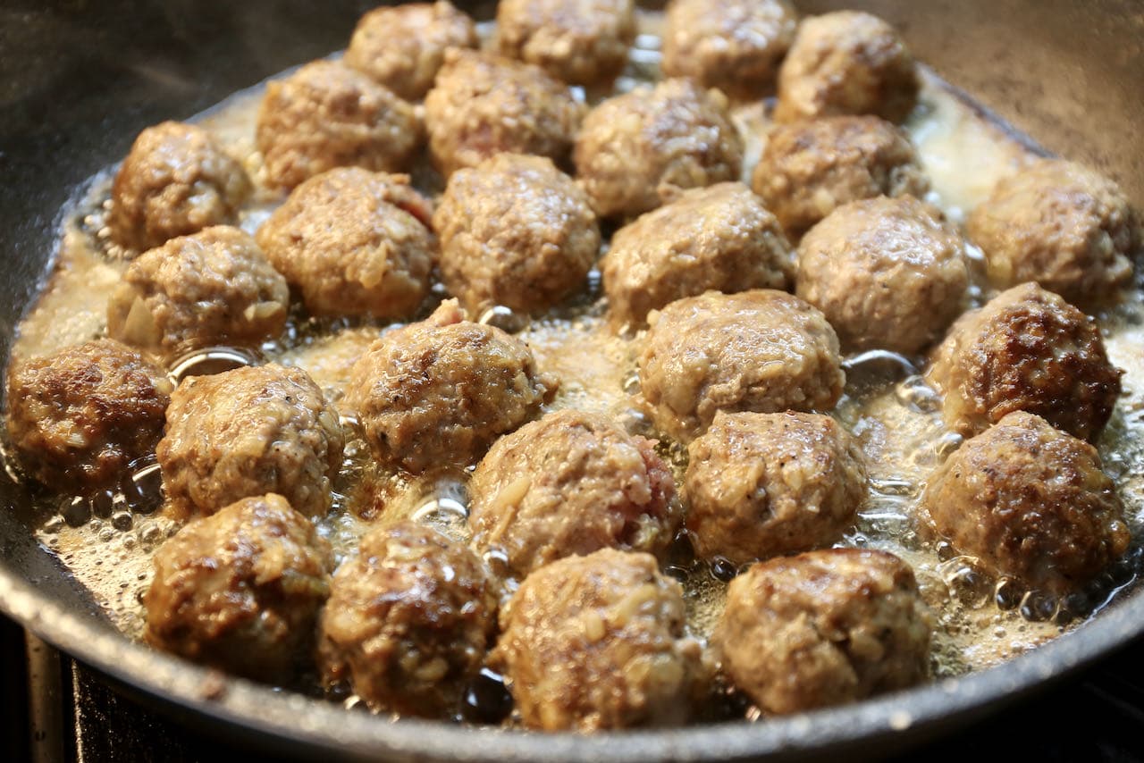 Köttbullar are finished cooking once they have browned and have a crispy exterior.